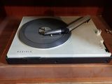 a record player sitting on top of a wooden table