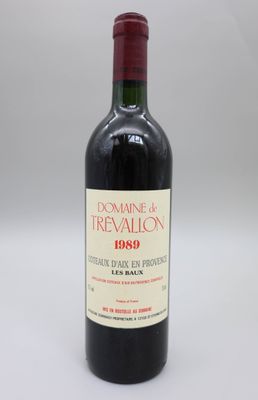 une bouteille de vin rouge posée sur une table blanche