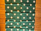green and white polka dot fabric with white dots on it