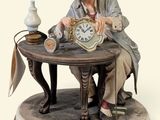 a figurine of a man sitting at a table with a clock