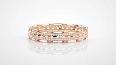 a stack of three rose gold and diamond bracelets