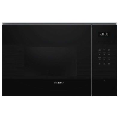 un four à micro-ondes noir posé sur un comptoir blanc