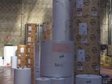 several rolls of paper are stacked on top of each other in a warehouse
