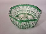 an image of a green and white glass bowl sitting on a table
