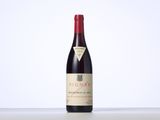 a bottle of red wine sitting on top of a table