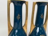 two vases that are sitting on a table