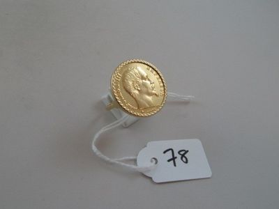a gold coin on a string with a price tag attached to it
