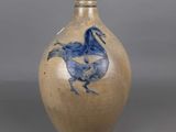 a blue and white vase with a bird on it