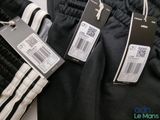 three pairs of black and white pants with price tags on them
