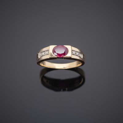 a gold ring with a ruby stone and diamonds