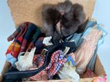 a box full of clothes and a teddy bear inside of it