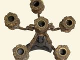 a metal candle holder with four candles on it