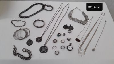 many different types of necklaces and bracelets laid out on a table