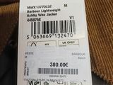 a person holding a tag with a barcode on it