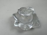a clear glass candle holder on a white table