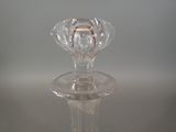 a clear glass candle holder on a table