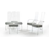 three clear chairs and a stool are sitting in a white room