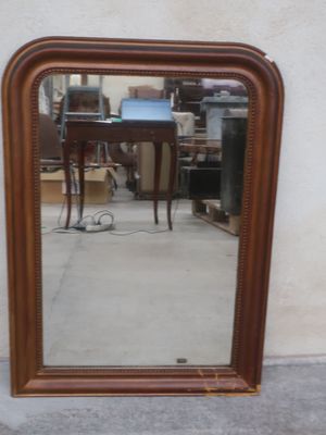 a mirror that is sitting on the ground in front of a wall