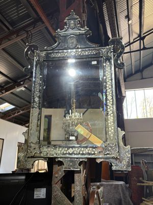 a large mirror hanging from the ceiling in a room