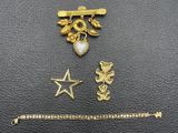 a close up of a gold bracelet, a star, and a bracelet
