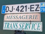two street signs attached to the side of a building