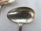two spoons that are sitting on a table