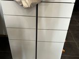 a white chest of drawers with a blanket on top of it