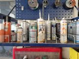 many different types of paint on the shelf