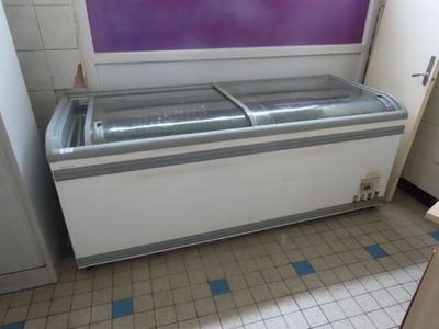 a refrigerator that is sitting in the corner of a room