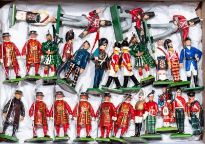many toy soldiers in a box on a table