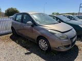 a car that has been damaged and is parked on the side of the road