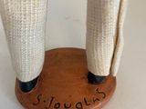 a close up of a figurine of a person holding a knife