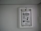 a label attached to the back of a toilet seat