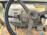 a steering wheel of a construction vehicle on the ground