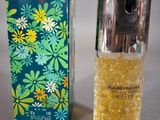 an image of a bottle of perfume next to a box of perfume