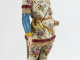 a figurine of a man with a bird on his head