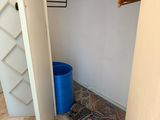 a blue trash can sitting in the corner of a closet