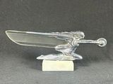 an image of a silver statue of a man on a skateboard