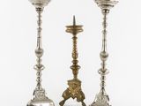 a pair of silver candlesticks on stands on a white background