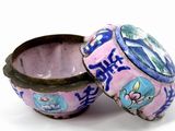 a small pink box with blue and white designs on it