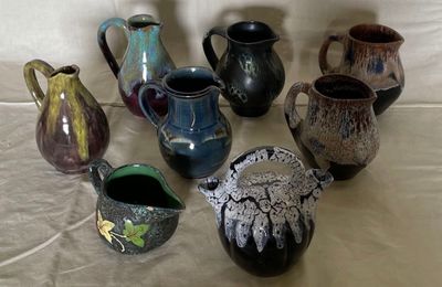 a lot of vases that are sitting on a table