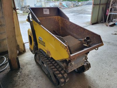 a small yellow machine that is parked in a garage
