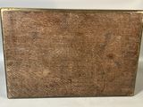 an old wooden box sitting on top of a white table