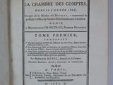 an open book on a white surface with a black and white title
