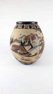 a vase with a painting on it on a white surface