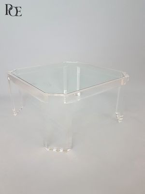 rectangular clear acrylic coffee table with acrylic legs and a glass top