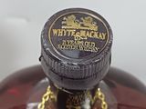 a bottle of whiskey with a gold chain around it