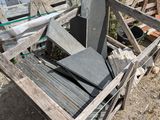 a pile of concrete blocks sitting on the ground next to a fence