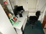 a desk with a chair and a computer on it