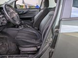 the interior of a car with the door open and the driver ' s seat down